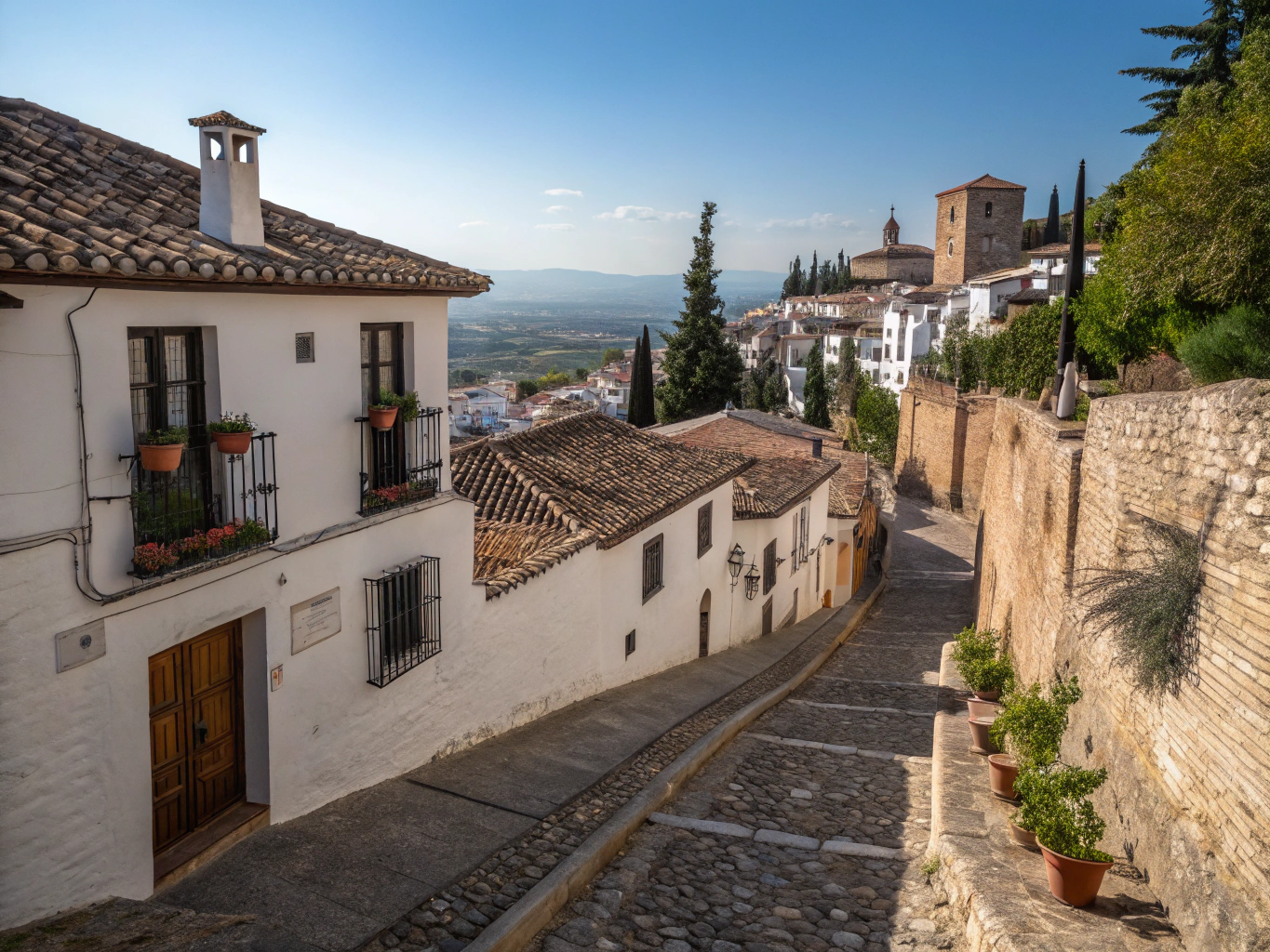 Sunlit white village and olive groves across the rolling hills of Andalucía